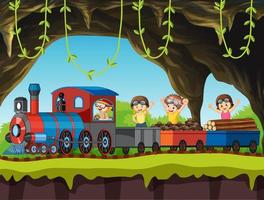 Children riding on train through the cave vector