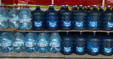 Sidoarjo, Jawa timur, Indonesia, 2022 - stock of gallons of 'aqua' and 'le mineral' at the mini market photo