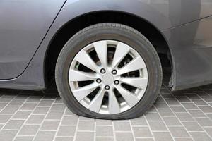 Car flat tire on tiled floor photo