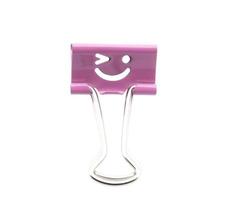 Smile pink binder clip isolated on white background photo