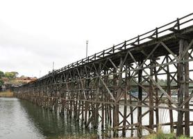 Mon Bridge crossing Songkalia River, the Thailand's longest wooden bridge, Sangkhla Buri District in Kanchanaburi, Thailand photo