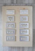 Old switch board installed on old marble wall photo