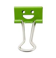 Smile green binder clip isolated on white background photo