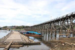 Mon Bridge crossing Songkalia River, the Thailand's longest wooden bridge, Sangkhla Buri District in Kanchanaburi, Thailand photo