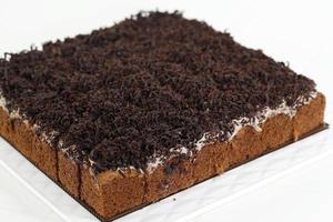 Small Square Sponge Cakes Cake Potong with Chocolate Shredded Dark Cooking Chocolate and Cream photo