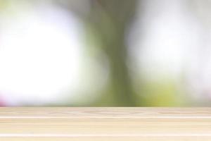 Empty wooden table with blurred light bokeh on background space background montage style, For place the product. photo