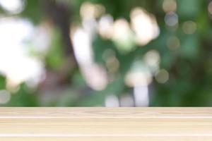 Empty wooden table with light bokeh in garden space background montage style, For place the product. photo