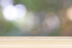 Empty wooden table with light bokeh in garden space background montage style, For place the product. photo