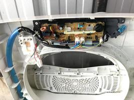 Control panel for top-loading washing machines, Service technician replacing new parts photo