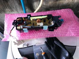 Control panel for top-loading washing machines, Service technician replacing new parts photo