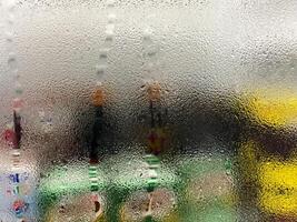 Dew on the glass against an opaque background. Texture of water droplets for wallpaper and copy space. photo