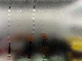 Dew on the glass against an opaque background. Texture of water droplets for wallpaper and copy space. photo