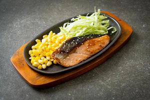 grilled salmon fillet steak on hot plate photo