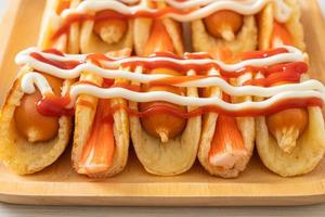 flat pancake roll with sausage and crab stick photo