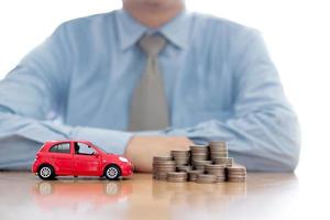 Person Protecting Increasing Stacked Coins And Car photo