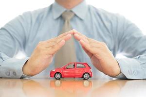 Businessman holding car photo