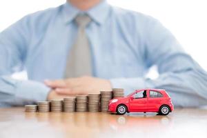 Person Protecting Increasing Stacked Coins And Car photo