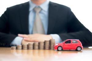 Person Protecting Increasing Stacked Coins And Car photo