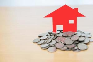 Red house sitting on a stack coins photo