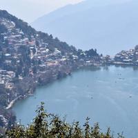 Full view of Naini Lake during evening time near Mall Road in Nainital, Uttarakhand, India, Beautiful view of Nainital Lake with mountains and blue sky photo