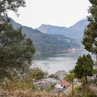 Full view of Naini Lake during evening time near Mall Road in Nainital, Uttarakhand, India, Beautiful view of Nainital Lake with mountains and blue sky photo