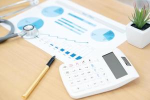 Stethoscope with business graph and calculator photo