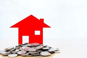 Red house sitting on a stack coins photo