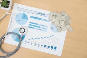 Stack of money coins with stethoscope checking photo