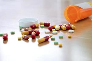 Pills and capsules in medical vial photo