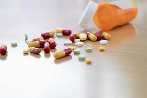 Pills and capsules in medical vial photo