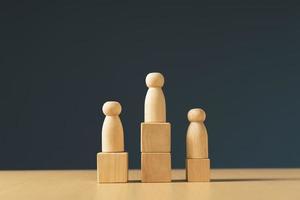 ranking and strategy concept, wooden figures peg doll standing on the podium photo