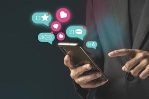 Person using a social media marketing concept on mobile phone with notification icons of like, message photo