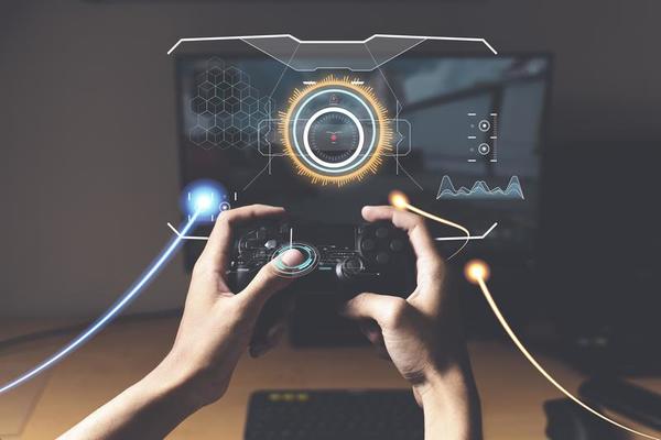 Gaming controller in hands, playing games and online streaming with gamer  competition and esports. Video game tech, streamer person in dark room and  play tournament with joystick and keyboard Stock Photo