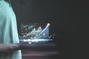 Businessman or trader is showing a growing virtual hologram stock photo