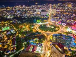 Panoramic coastal Vung Tau view from above, with traffic roundabout, house, Vietnam war memorial in Vietnam. Long exposure photography at night. photo