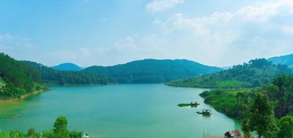 Tuyen Lam lake at Dalat, Vietnam, beautiful landscape for eco travel at Viet Nam, amazing lake among pine forest make wonderful scene, boat on water, Da Lat countryside is famous place for holiday photo