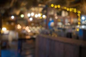 Blurred background Interior of cozy coffee shop. Contemporary design in loft style, modern dining place and bar counter, copy space. photo