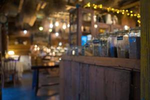 Blurred background Interior of cozy coffee shop. Contemporary design in loft style, modern dining place and bar counter, copy space. photo