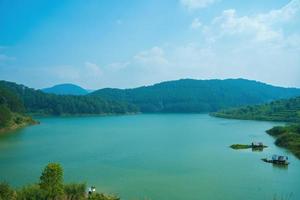 Tuyen Lam lake at Dalat, Vietnam, beautiful landscape for eco travel at Viet Nam, amazing lake among pine forest make wonderful scene, boat on water, Da Lat countryside is famous place for holiday photo