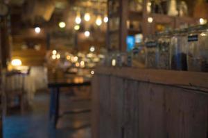 Blurred background Interior of cozy coffee shop. Contemporary design in loft style, modern dining place and bar counter, copy space. photo