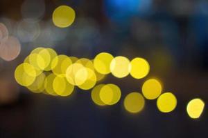 Night city bokeh glows light background empty. Banner candlelight shines yellow gold glitter abstract. Design background Celebration photo