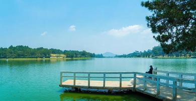 Fabulous sunrise by Xuan Huong Lake, in center Da Lat City, Lam Dong Province, Vietnam. This artificial lake in the city centre is a favourite place for tourists and locals for walking. photo