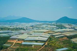 Amazing sunrise landscape in agricultural greenhouse valley in Da Lat City. The light from the greenhouse to grow flowers in Da Lat. Travel and landscape concept photo