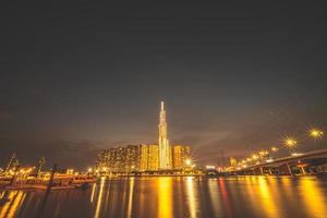 Ho Chi Minh city, Vietnam, FEB 11 2022 sunset view at Landmark 81 - it is a super tall skyscraper and Saigon bridge with development buildings along Saigon river light smooth down photo