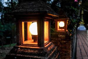 the integrated LED and ancient vintage cement lamp on brick wall. photo