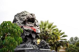 big black lion statue front of building. photo