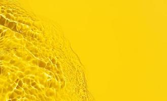Yellow Abstract background texture with water ripples and waves. Copy space. Top view photo