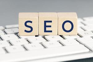 SEO word on wooden blocks on computer keyboard. Search Engine optimization concept photo