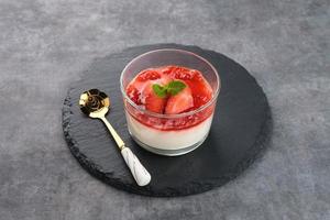Sweet vanilla silky pudding dessert with strawberry sauce photo