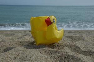 Inflatable duck on the beach photo